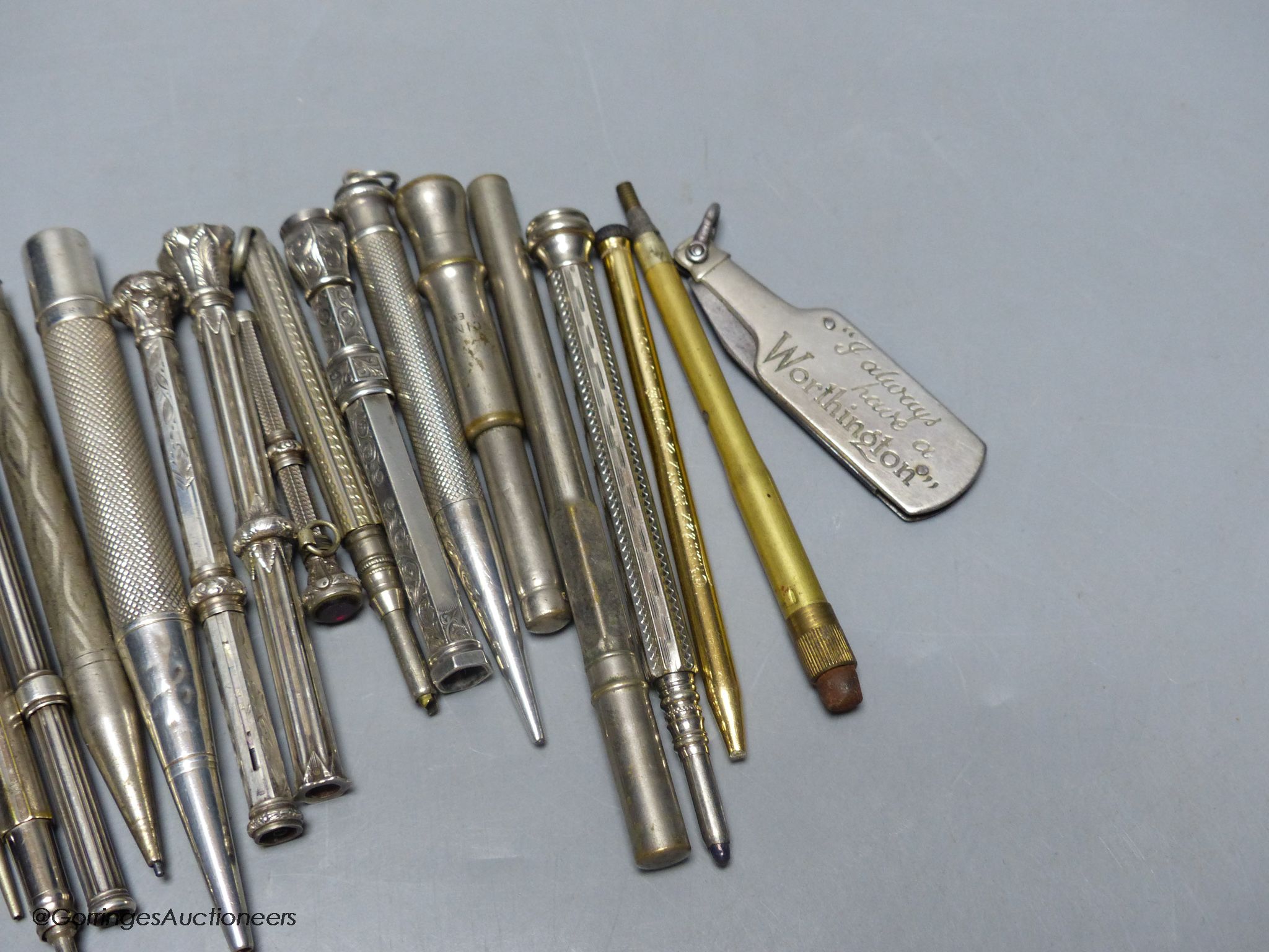 A group of silver and metal propelling pencils